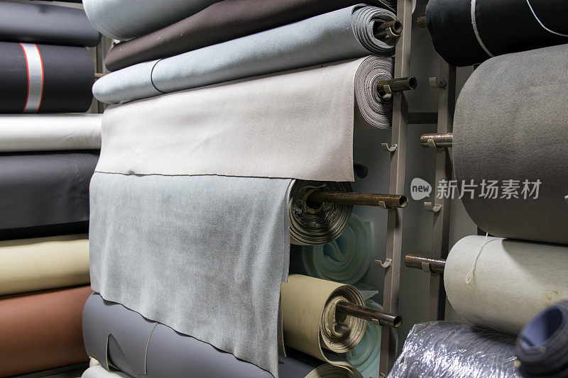 Зhoto of a warehouse filled with rolls of upholstery for car interiors